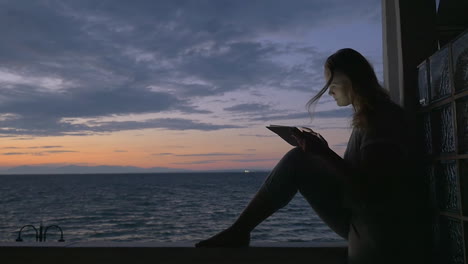 woman with tablet on the balcony