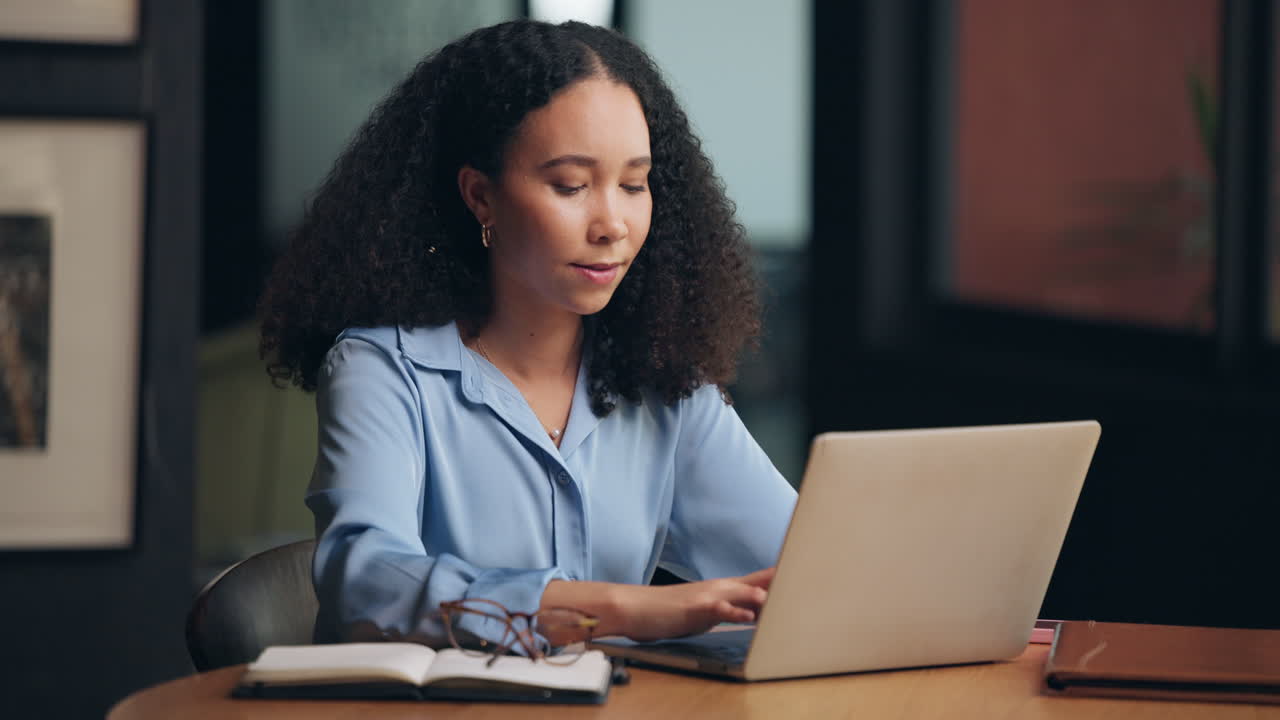 Woman working on laptop at desk