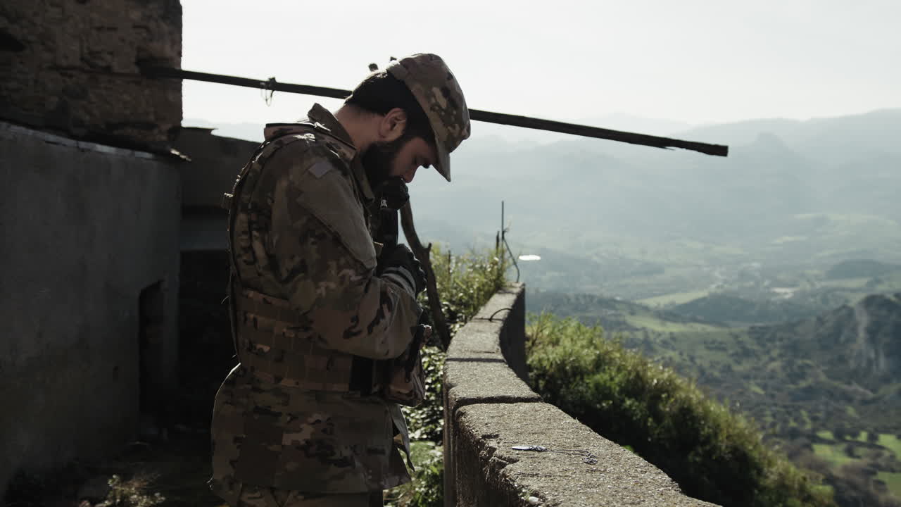 Soldier Adjusts His Gear During A Mission Under The Sun In The Balcony