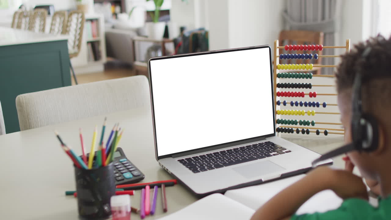 African american boy using laptop with copy space on screen