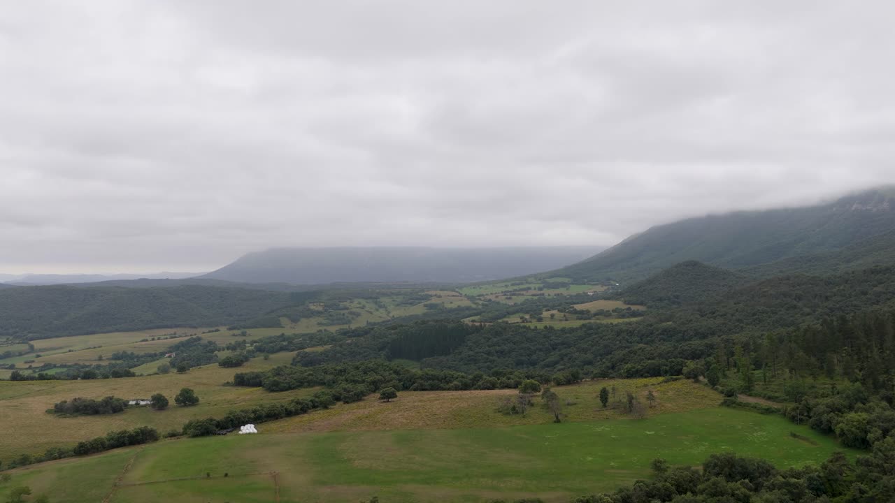 Aerial view of a vast rural valley on a cloudy day