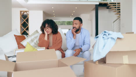 Frustrated-couple,-sofa-and-boxes-in-debt