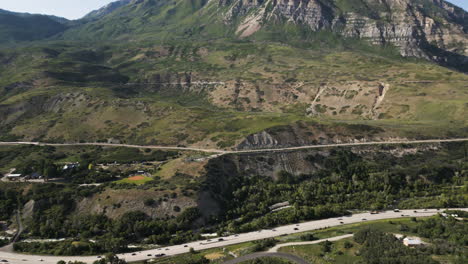 a drone tilts up from a highway reveal mount timpanogos in utah usa