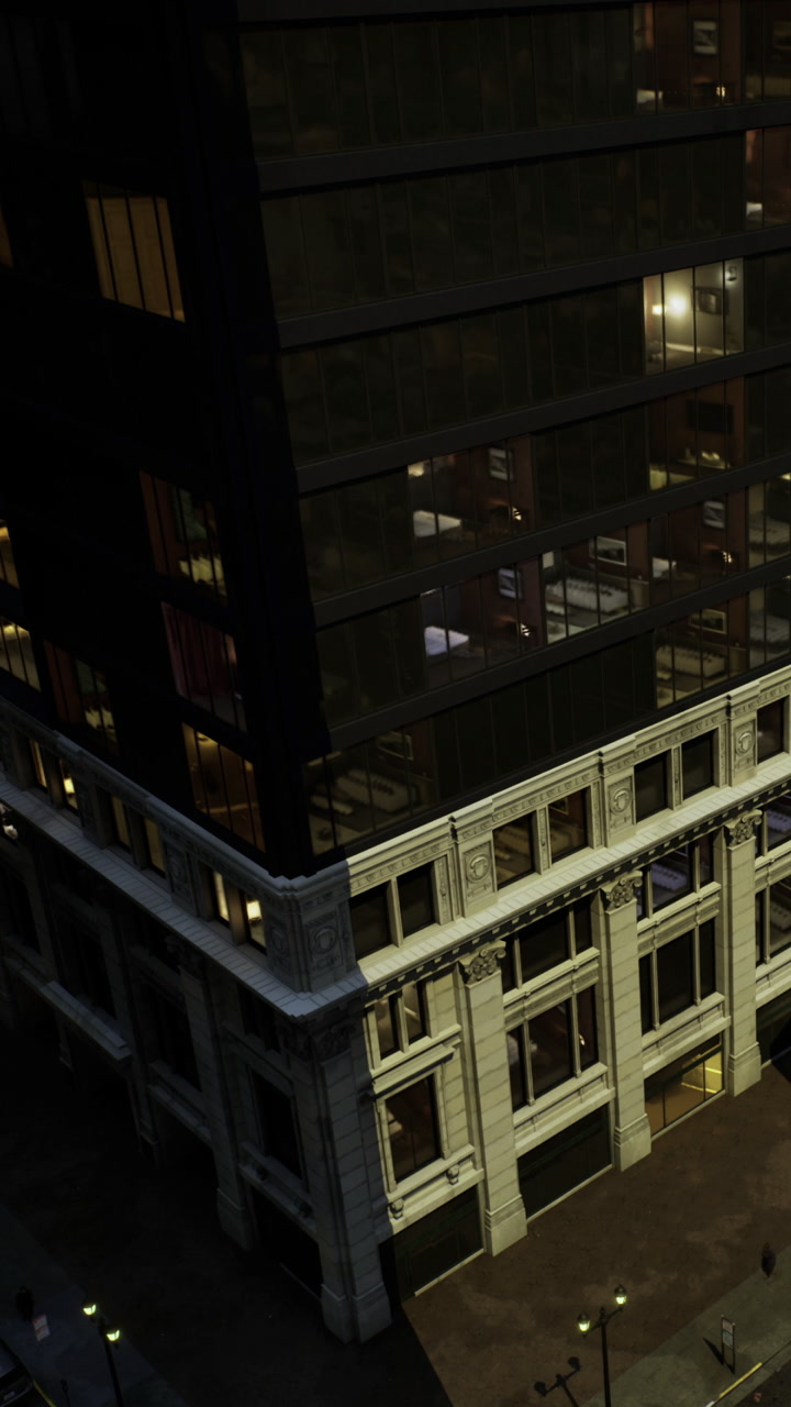 Building with lights on at night in a city