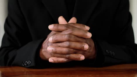 man praying to god with hands together on black background stock footage