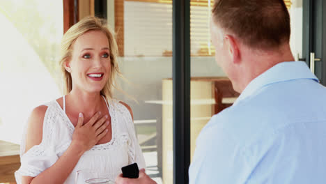 man giving engagement ring to surprised woman 4k