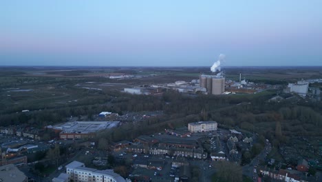 bury st edmunds with industrial buildings and residential areas at dusk, aerial view