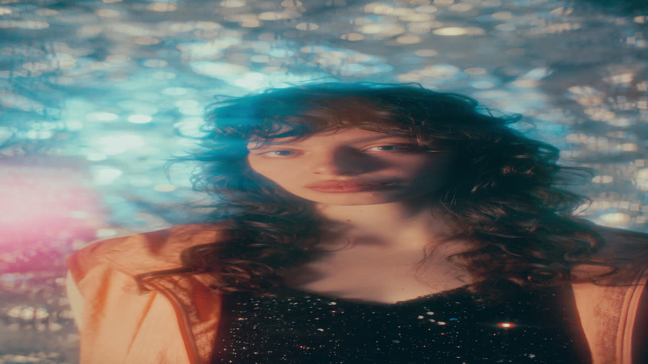Portrait of Young Beautiful Woman Standing against Shimmering Background