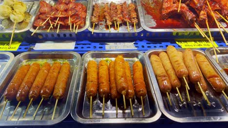 Close-up-shot-of-over-a-street-food-stall-selling-traditional-spicy-snacks-in-Chinatown,-Kuala-Lumpur,-Malaysia-at-night-time