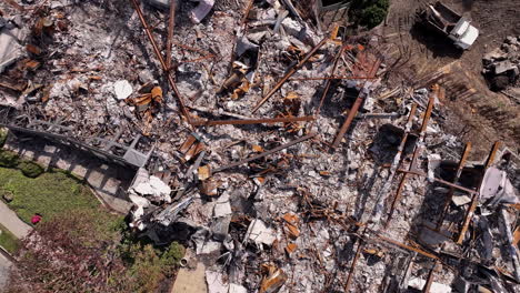 aerial view of extensive rubble and charred remains after a disaster