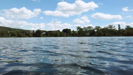 Ein-Atemberaubender-Blauer-Himmel-Spiegelt-Sich-Auf-Dem-Ruhigen,-Gekräuselten-Wasser-Eines-Sees-Nahe-Der-Tschechischen-Grenze-Wider