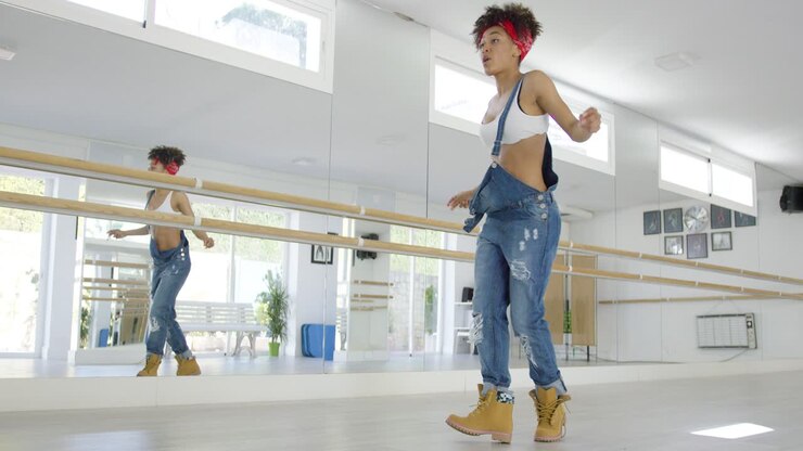 Dancer steps forward and snaps finger in studio