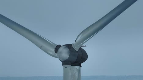 aerial view wind farm in winter close up, the blades rotate and generate electricity for consumers