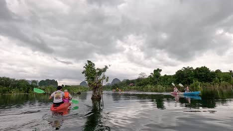 kayakers explore scenic canal in krabi, thailand