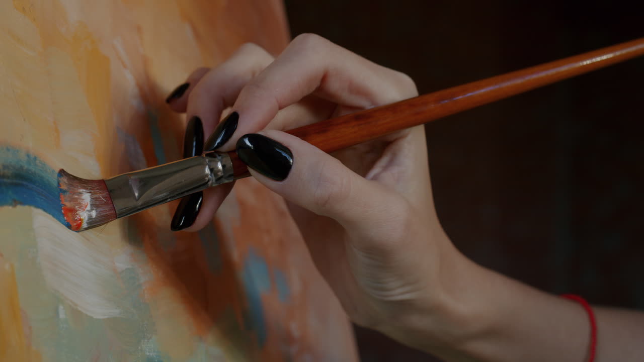 Close-up of an artist painting on canvas