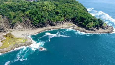 Pequeña-Bahía-Rocosa-En-La-Costa-Tropical-De-Karang,-Indonesia,-Vista-Aérea-De-La-Pintoresca-Laguna