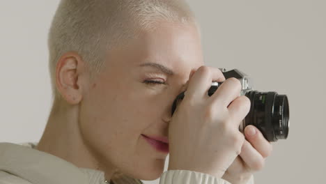 woman takes photograph on vintage camera 01