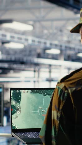 vertical video military data center specialist using radar software on laptop