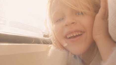 Girl-enjoying-sunlight-in-camper-bed