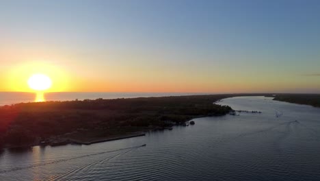 aerial view of a tropical river and ocean at sunset
