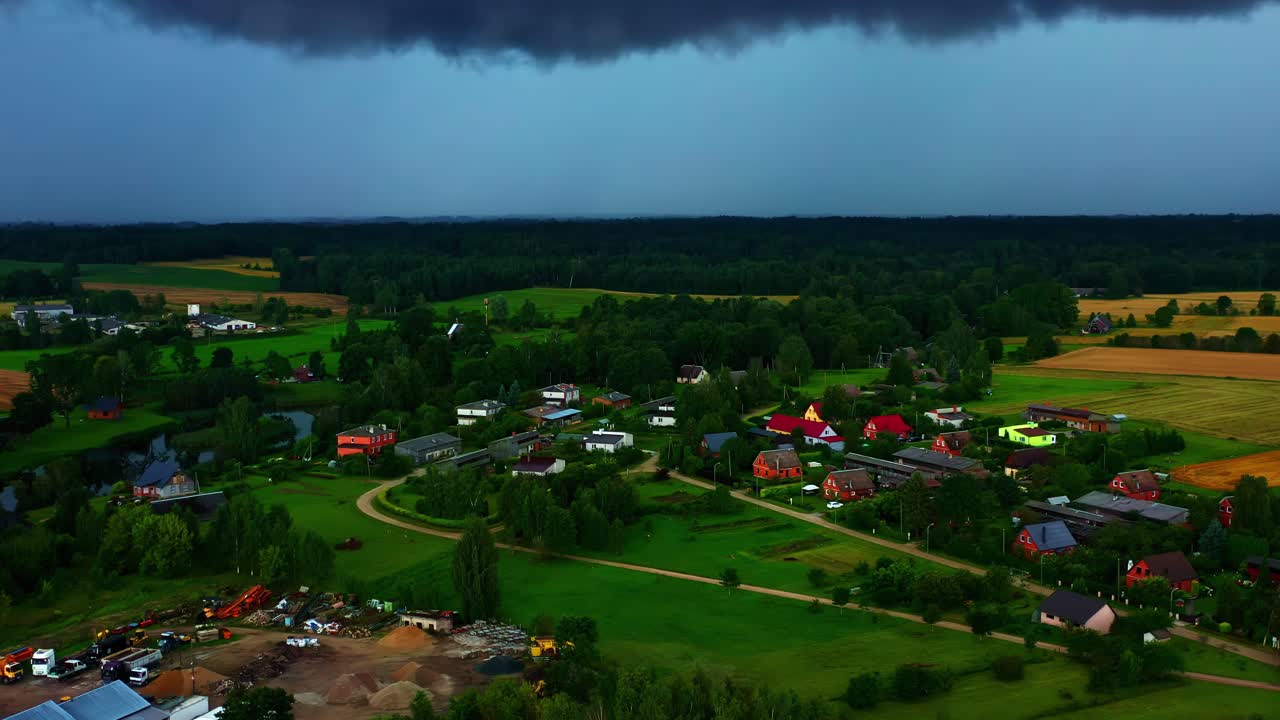 Small rural village under ominous pre-storm sky in late summer aerial view