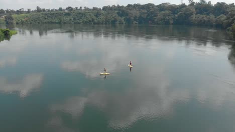 aerial shot flying over people on stand up paddle boards on the river nile in africa