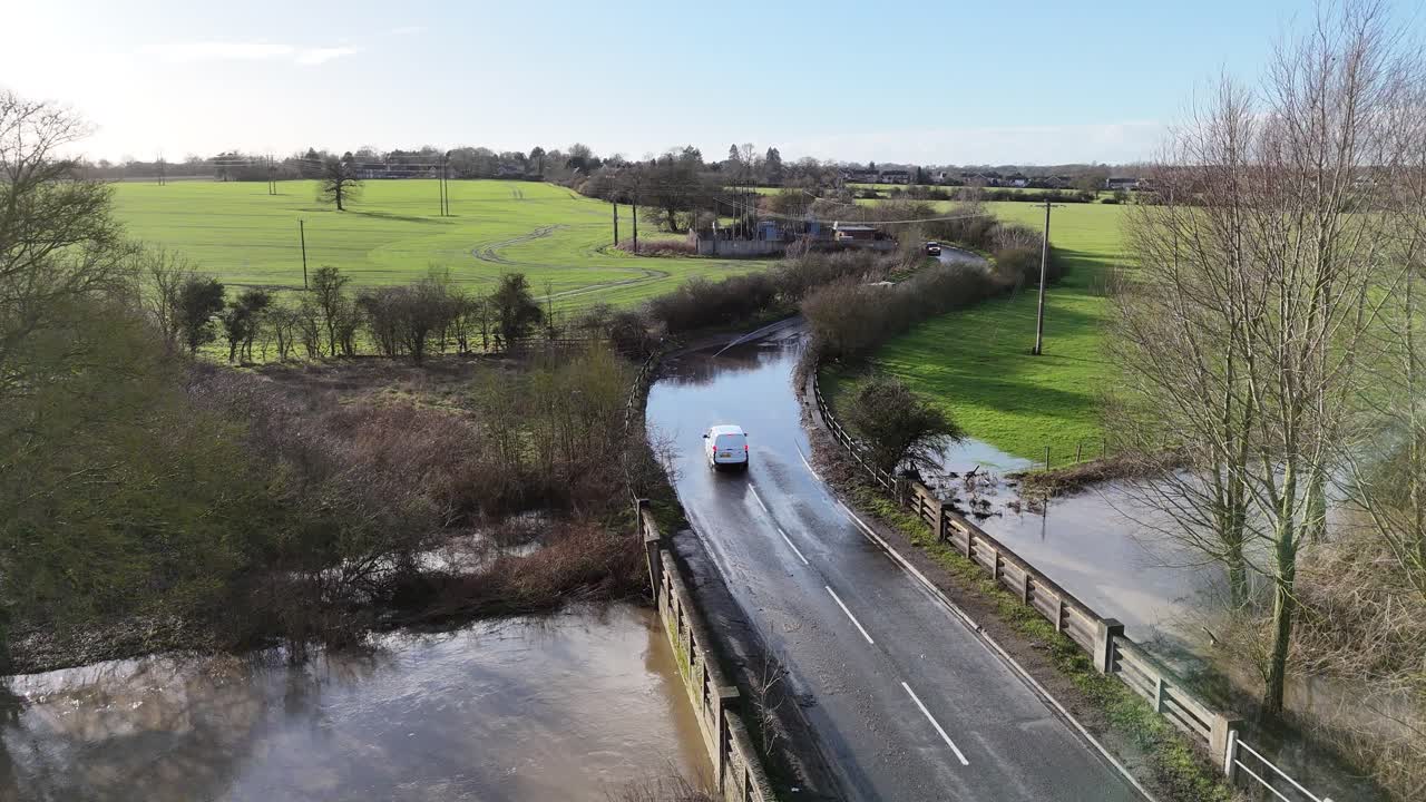 Van driving through flooded road Essex UK aerial view