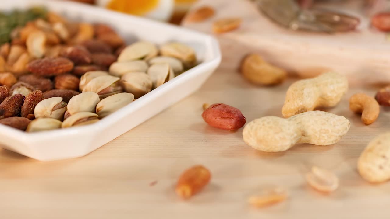 A variety of nuts and seeds displayed on a wooden table, highlighting their textures and colors.