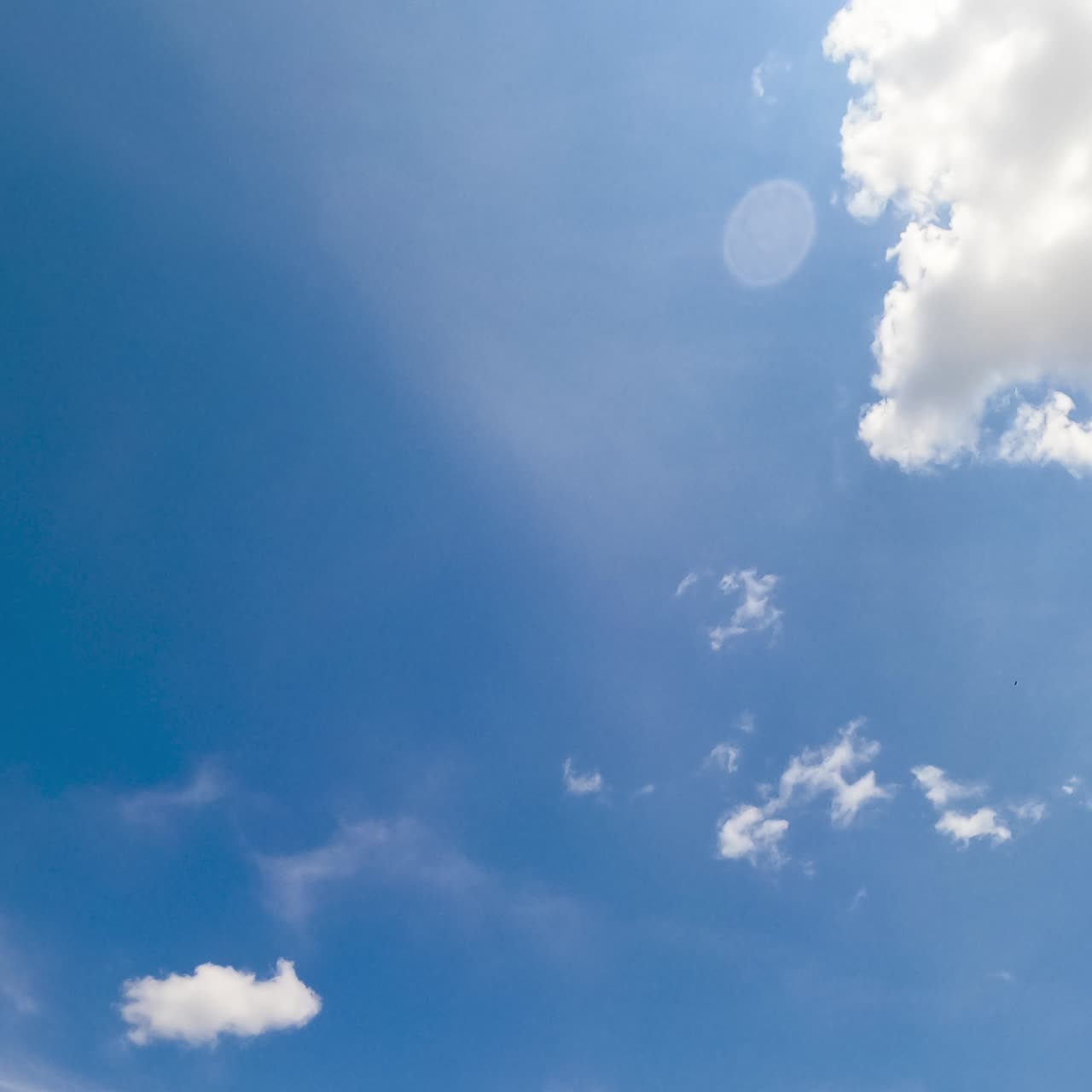 Beautiful light cirrus clouds in the atmosphere. Little clouds lit with hot summer sun. Low angle view. Timelapse