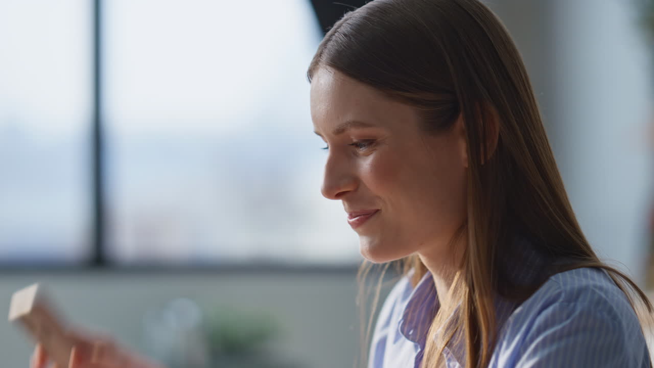 Smiling lady talking smartphone in home closeup. Happy woman finishing cellphone
