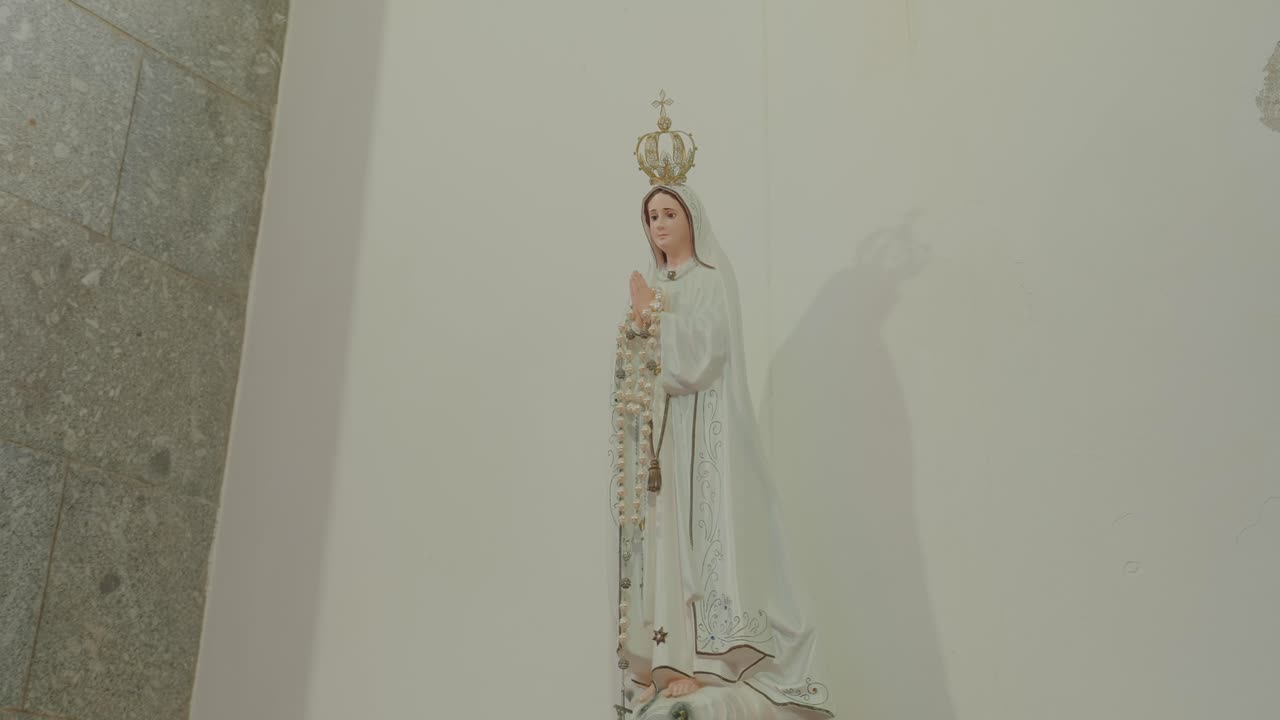 Religious statue of Our Lady of Fátima inside a church setting