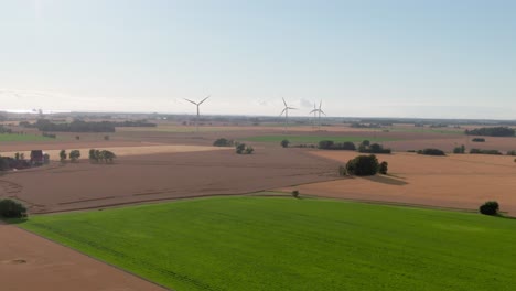 Wide-panoramic-aerial-over-Swedish-countryside-with-wind-turbines