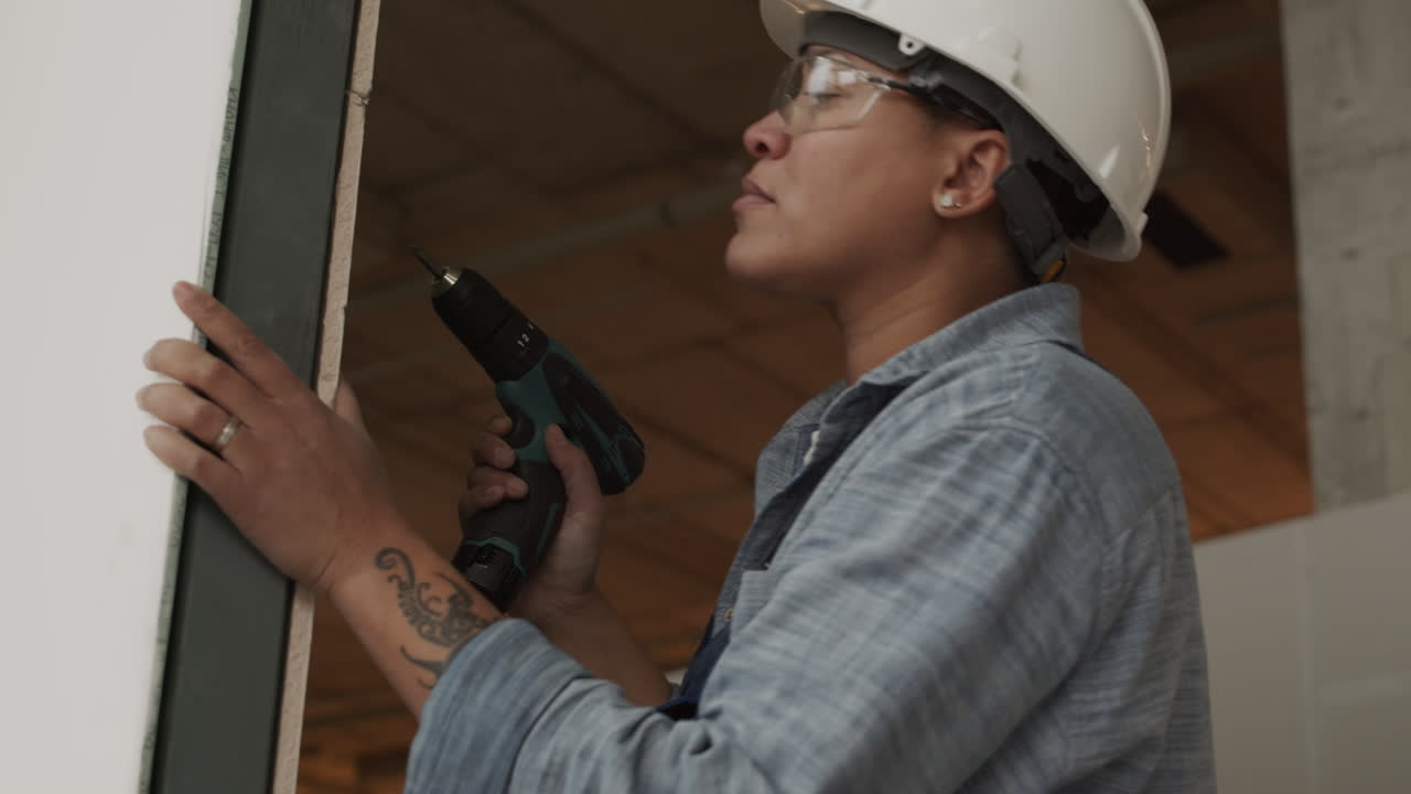 Biracial Worker Using Drill
