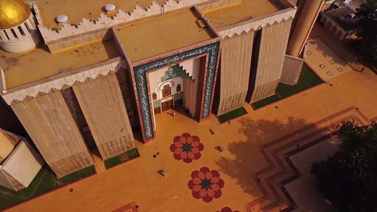 Top down aerial of person walking over the large square in front of the Abuja National Mosque in Nigeria, Africa