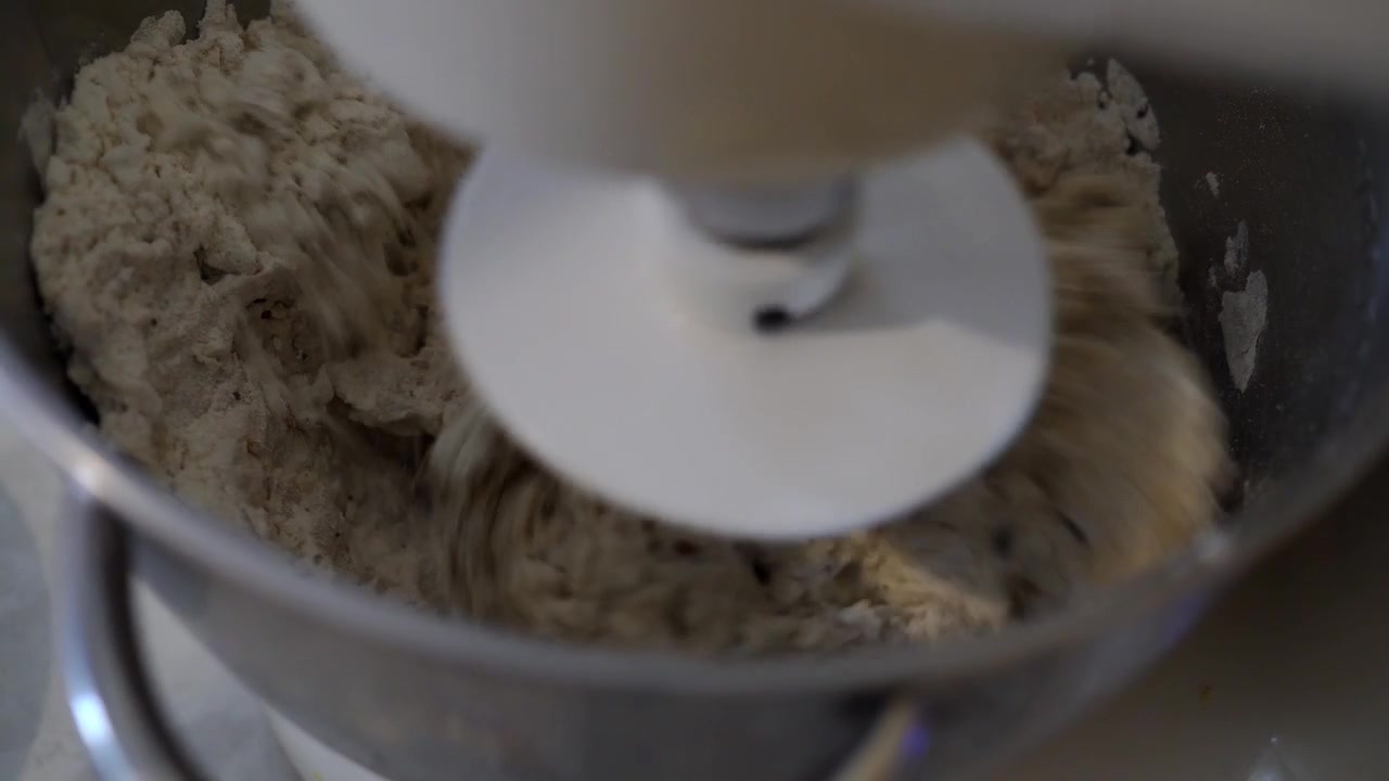 Adding water to a yeast dough while kneading with a dough hook using a planetary mixer