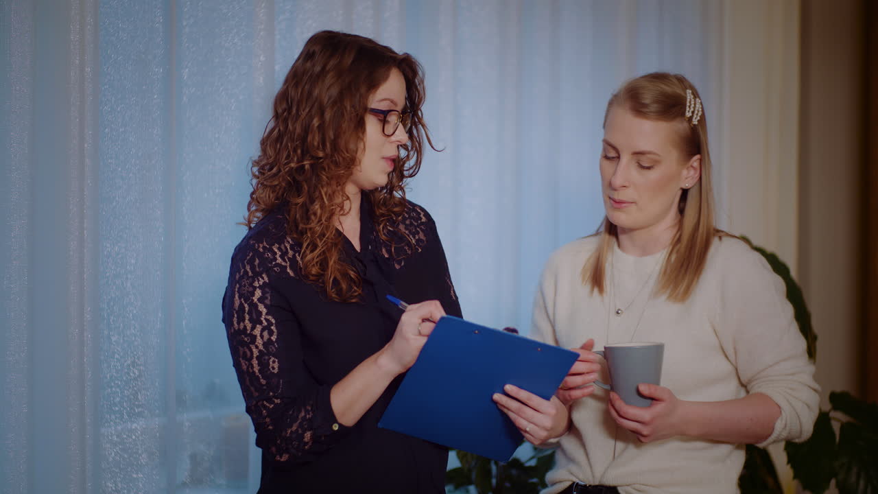 Two women discussing business in the office