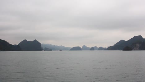 Navegando-En-La-Bahía-De-Halng-Con-Las-Rocas-Al-Fondo-En-Una-Mañana-Nublada