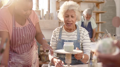 Happy-diverse-female-potters-working-in-pottery-studio,-slow-motion