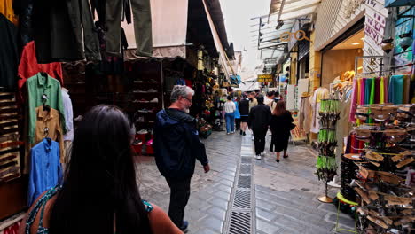 bustling market street with shoppers and souvenir stalls