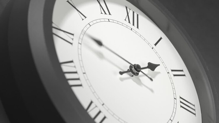 Latin Clock Face in Time Lapse on Dark Grey Wall