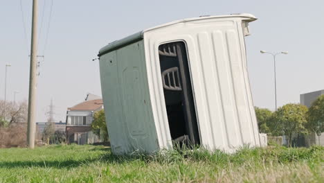 cabin of a destroyed and abandoned van in the green meadow of a farmer in the countryside during sunny day - static medium shot low angle