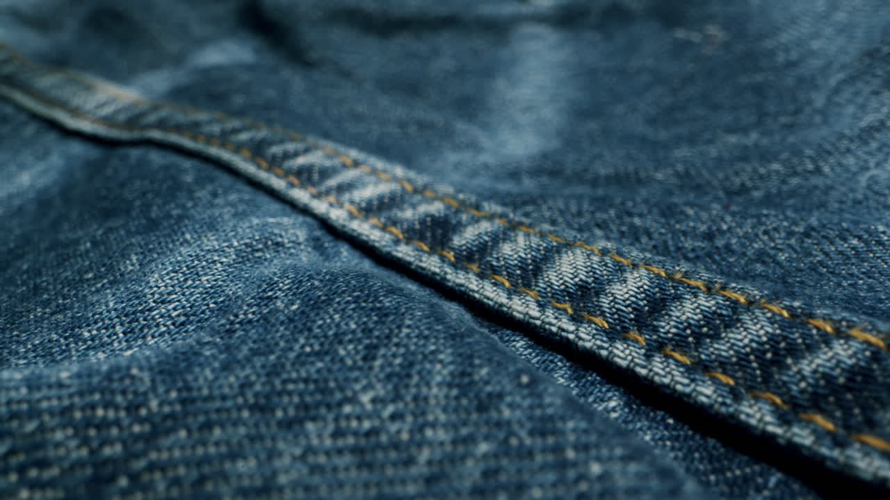 Blue textile jeans cloth texture close-up macro. Fashion fabric multicolor. Cotton casual clothes