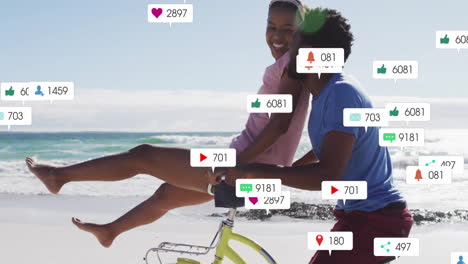 riding bicycle on beach, social media notifications animation over couple