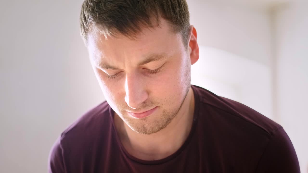 A Thoughtful Moment: Capturing a Young Man's Introspective Reflection in Two Frames, Highlighting Emotion and Concentration in a Minimalistic Setting