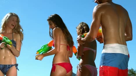 Happy-friends-doing-water-gun-battle