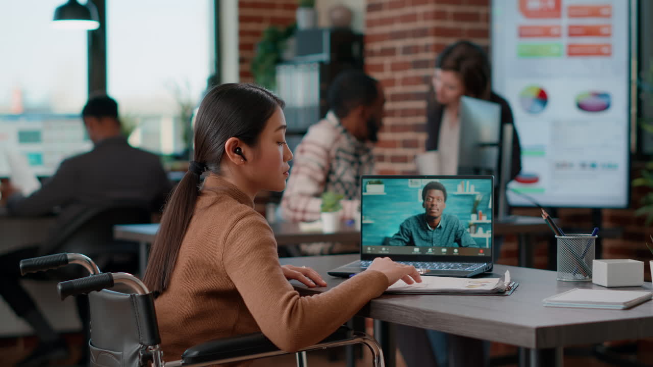 Office worker in wheelchair talking on remote videocall