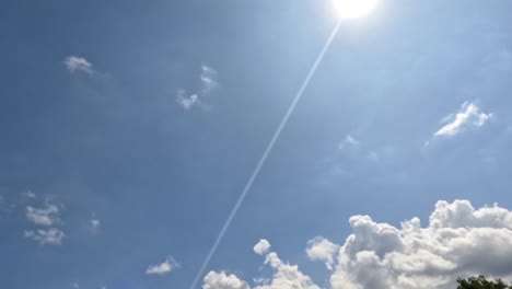 time lapse of the movement of white clouds in a blue sky, weather changing from sunny to slightly cloudy