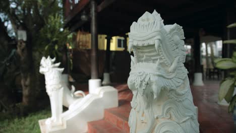 white chinese ornament dragons accentuating the entrance of a thai traditional house