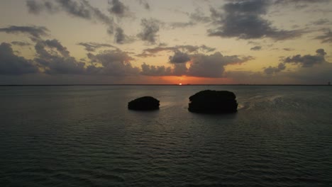 drone shot of small islands off the coast of cancun, mexico during a beautiful warm sunset