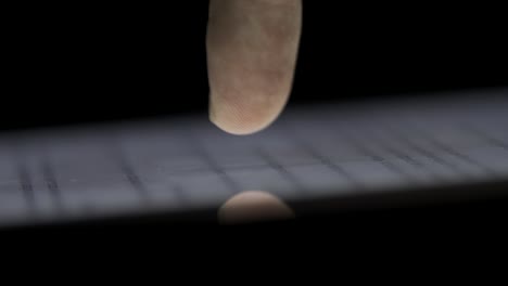 finger touching a tablet screen